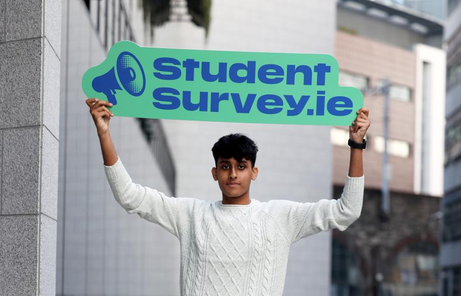 Student holding banner
