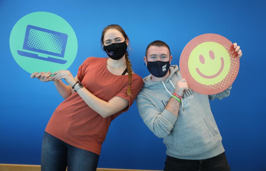 Students holding Student Survey props