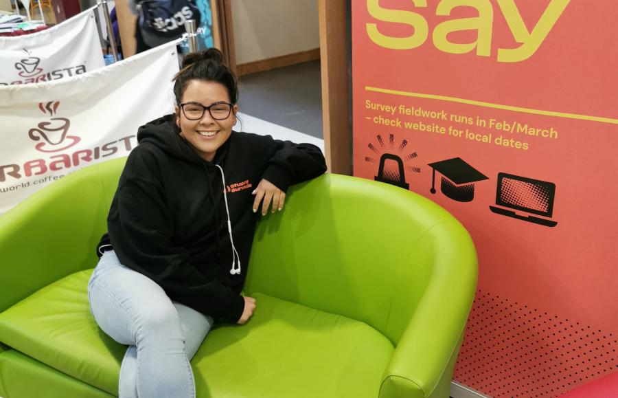 Student on couch with merch