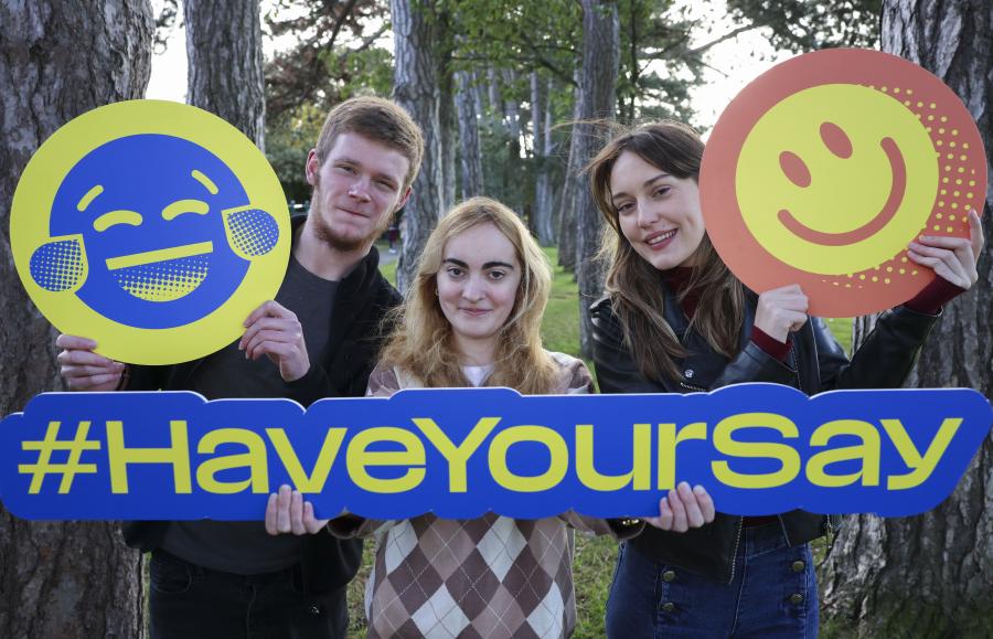 Students holding Student Survey banners