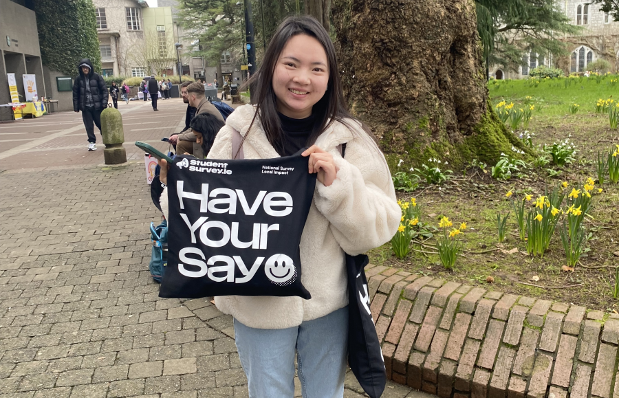 Student holding merch